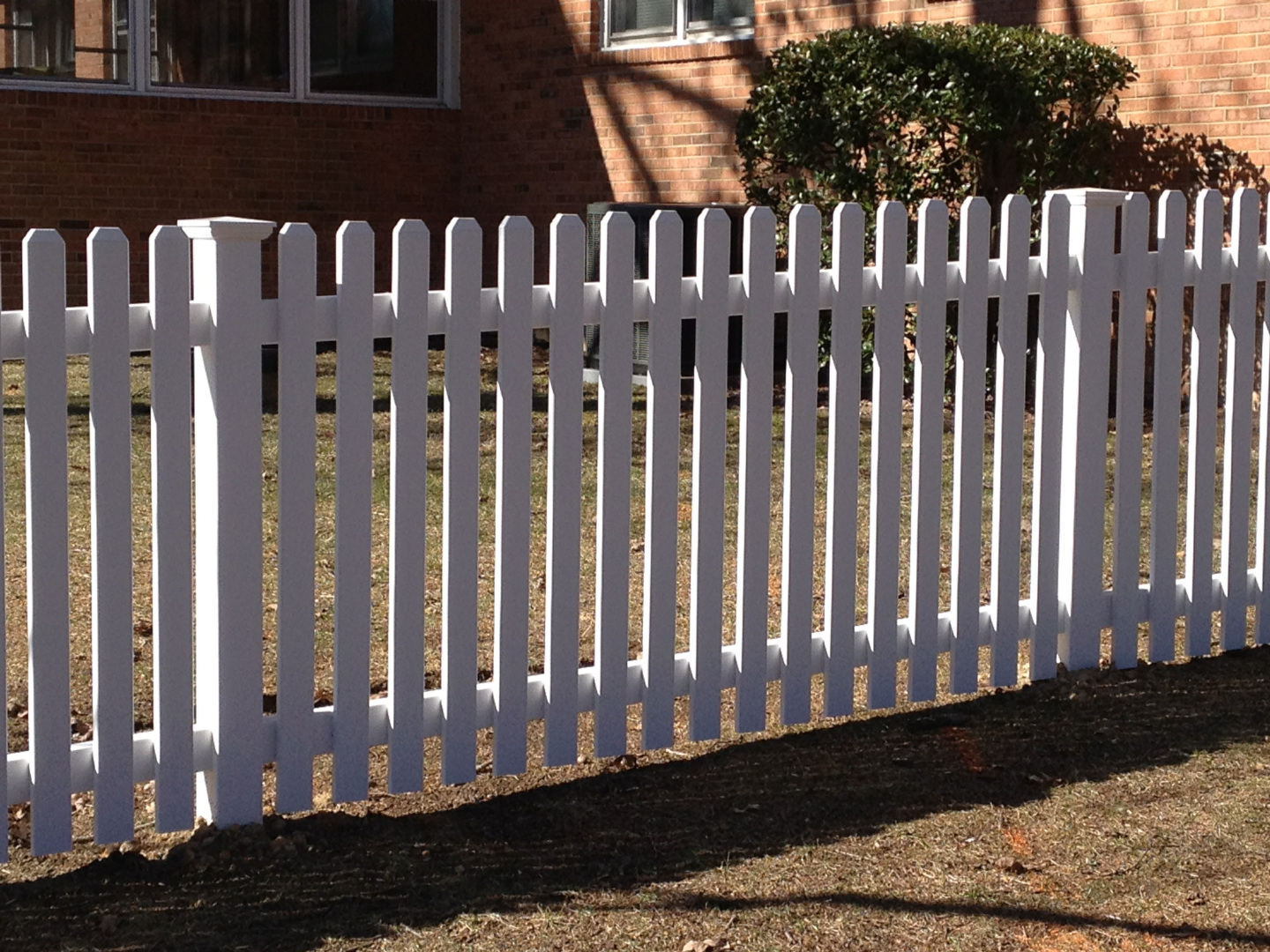 Four foot dogear vinyl picket fence featuring new england style post caps.
