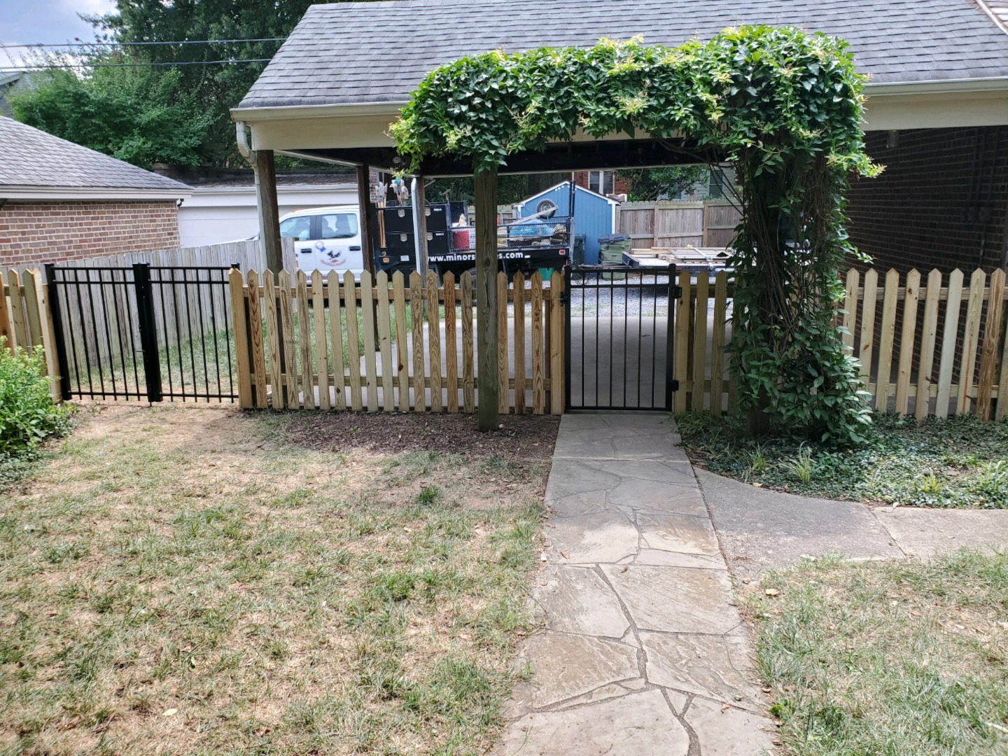 Four foot 45 degree pointed picket fence with aluminum gates.