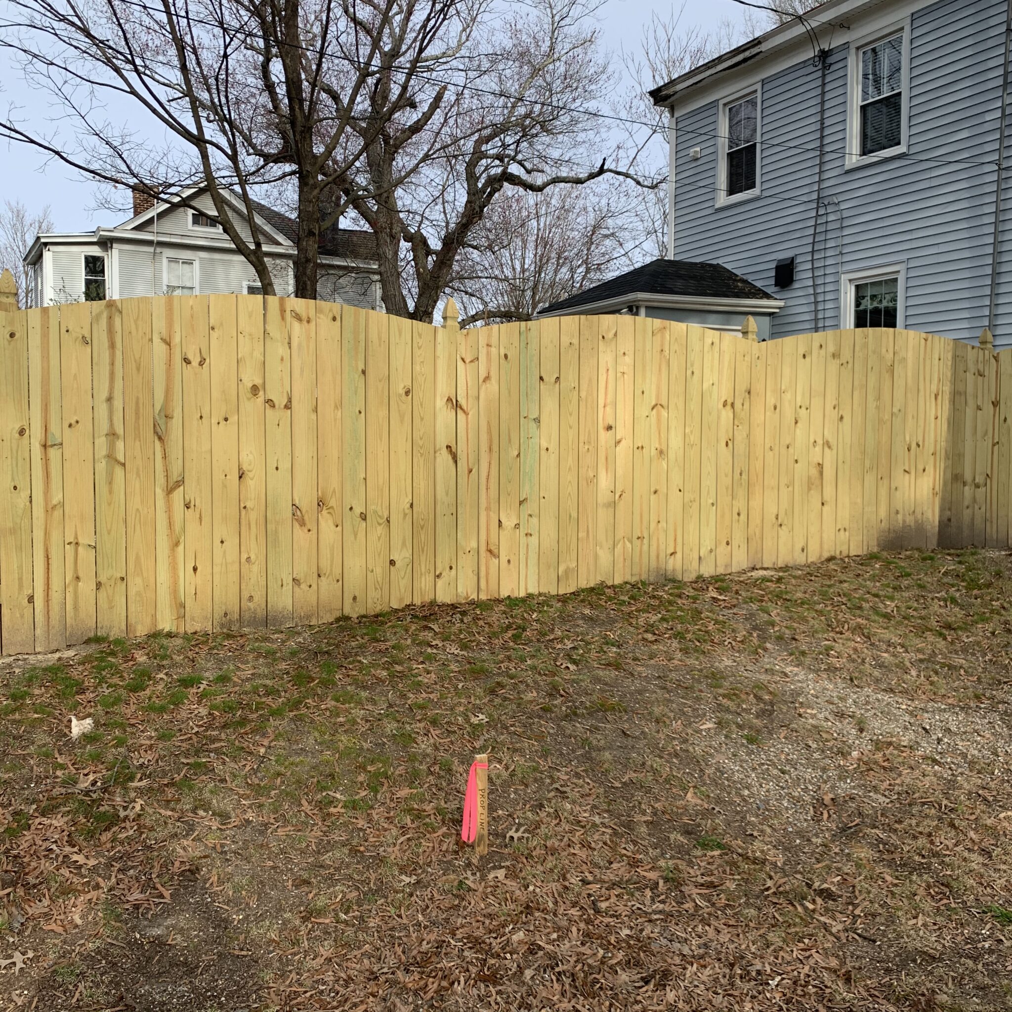 6 foot high convex wood privacy fence with French Gothic posts
