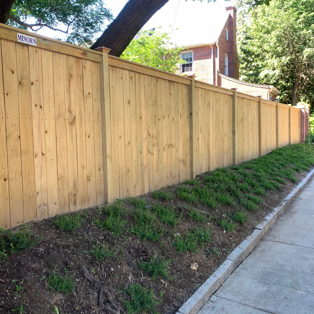 Six foot tall top cap and finish board fence with customer installed post caps.
