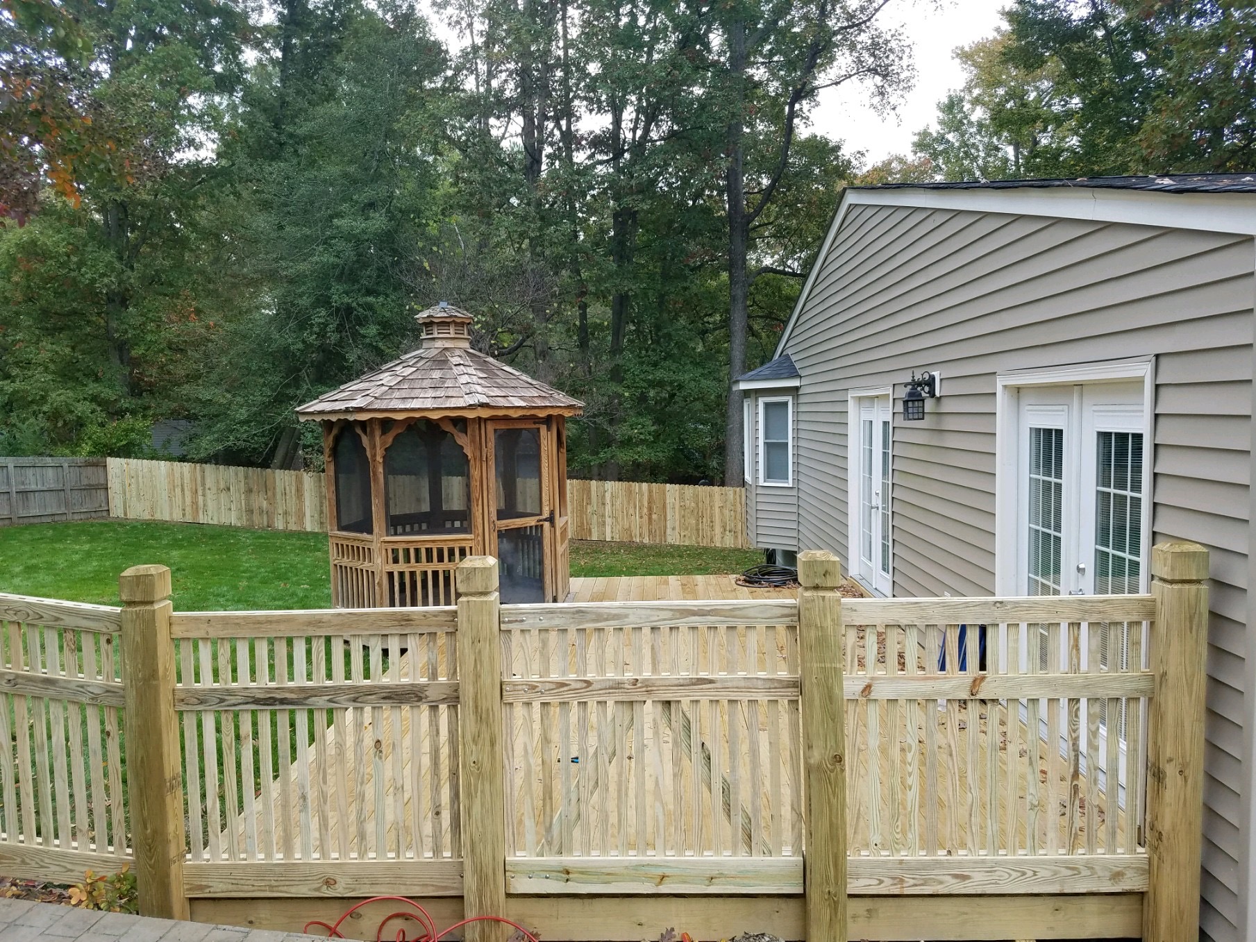 Framed picket fencing on beveled and notched exposed posts