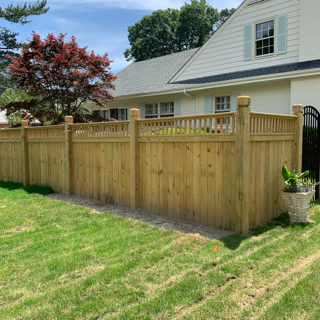6 foot high wood privacy fence with flat top pickets and 6 by 6 beveled and notched posts.