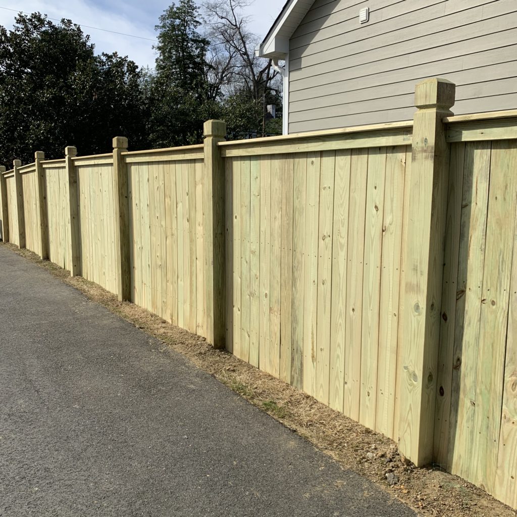 Six foot top cap and finish board wood privacy fence with 6x6 beveled and notched posts.