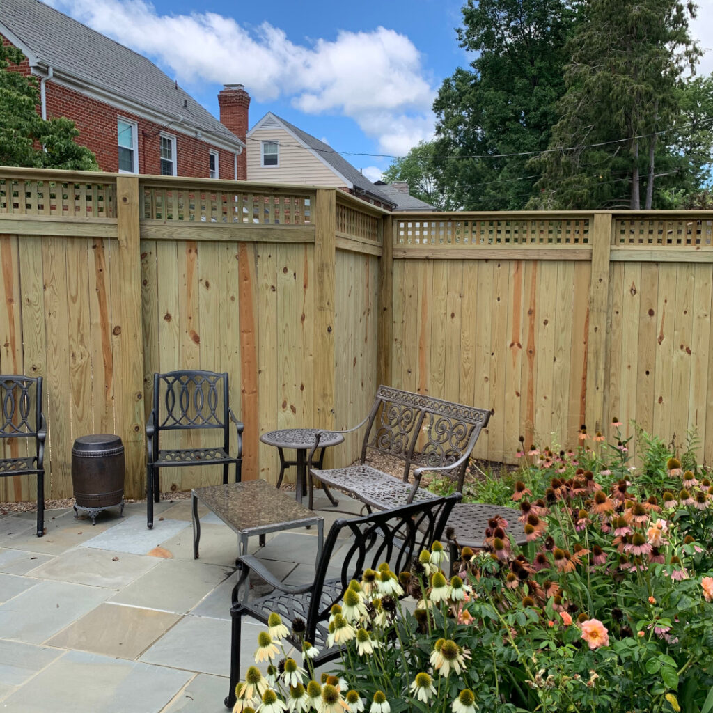 7 foot 7 inch high wood privacy fence featuring horizontal lattice.