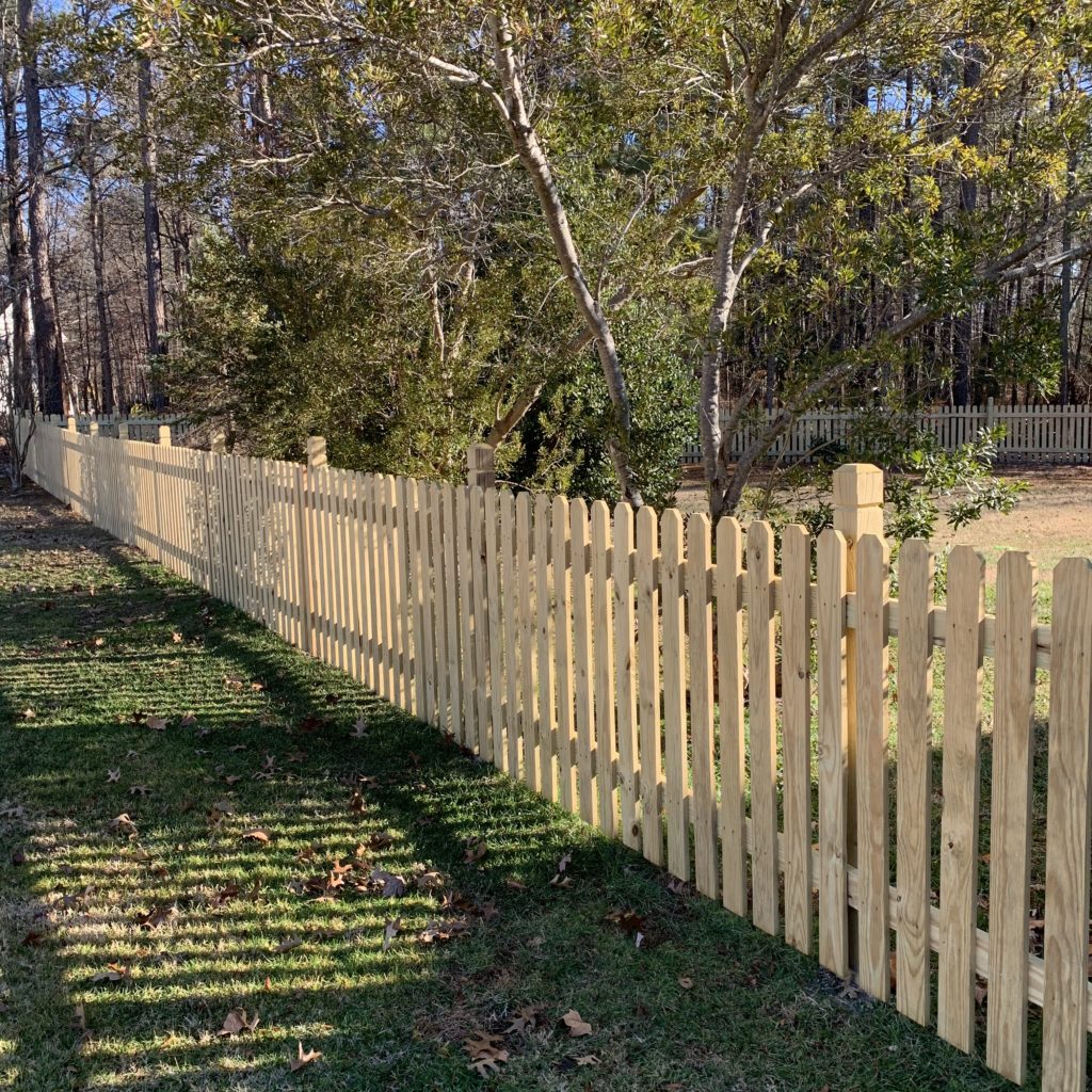 Dogear picket fence with beveled and notched posts.