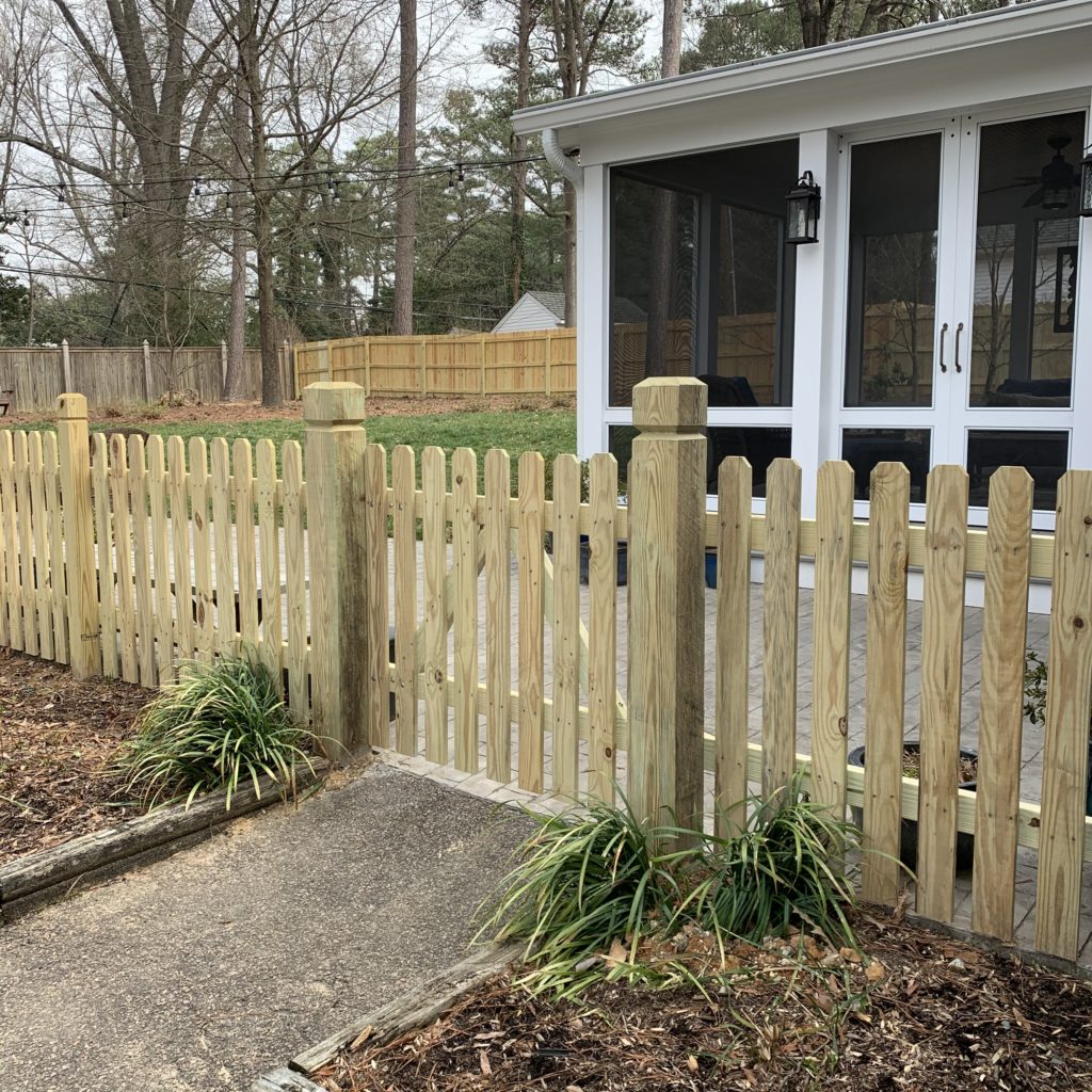 Dogear picket fencing on beveled and notched posts